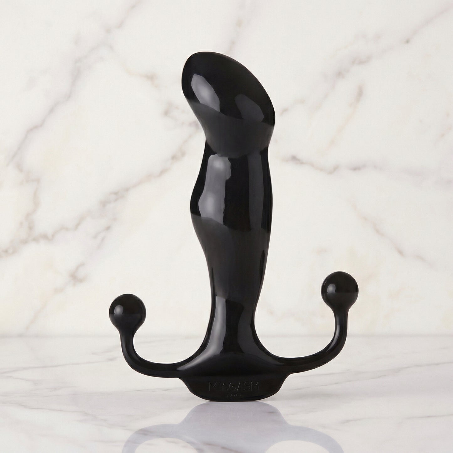 Zwarte glanzende prostaat massager met perineum-armen op marmeren achtergrond